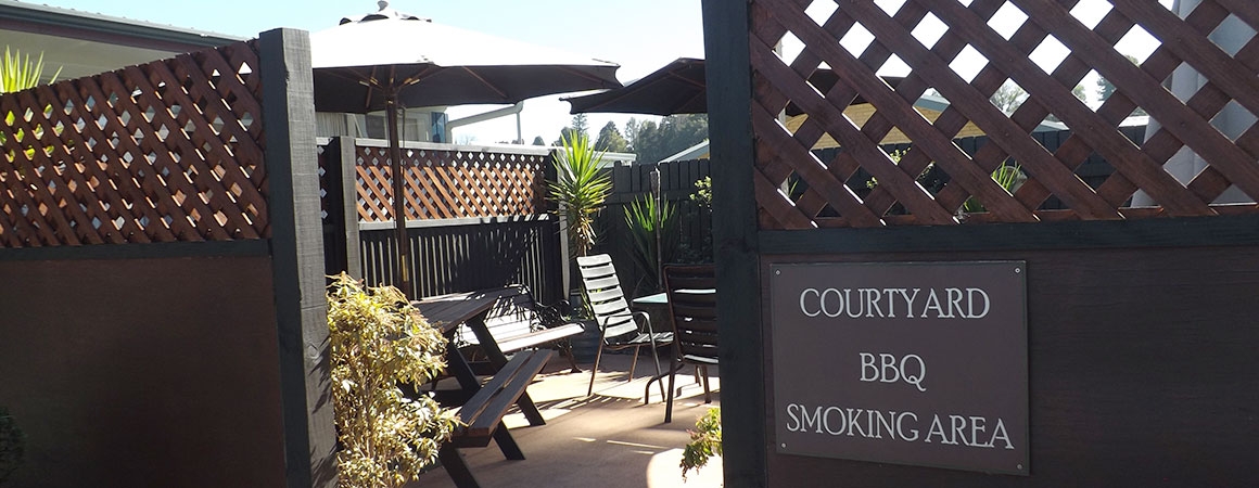 sunny courtyard with BBQ and plenty of seating